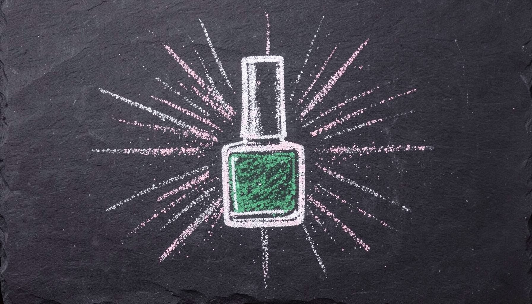 A chalk drawing on a dark slate board of a single nail polish bottle with shimmer particles radiating outward in soft white and pale pink chalk.