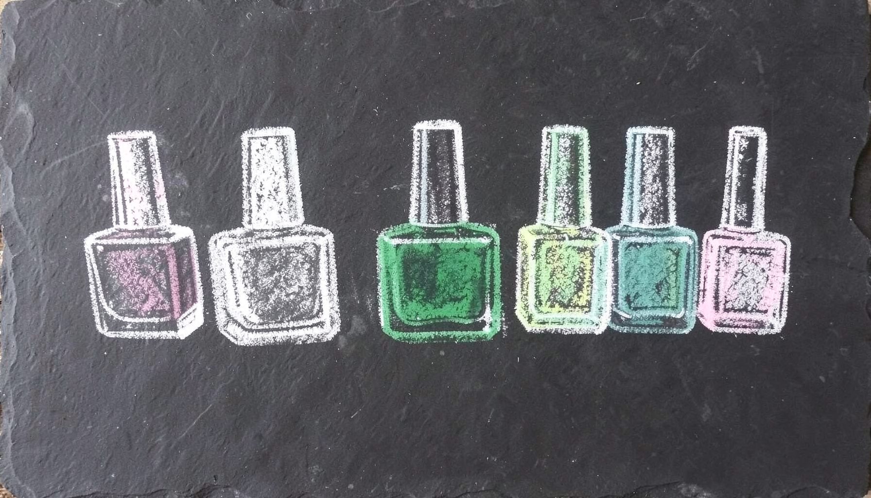 A chalk drawing on a dark slate board showing a row of nail polish bottles in varied shapes, with soft white and pastel chalk strokes against the deep charcoal background.