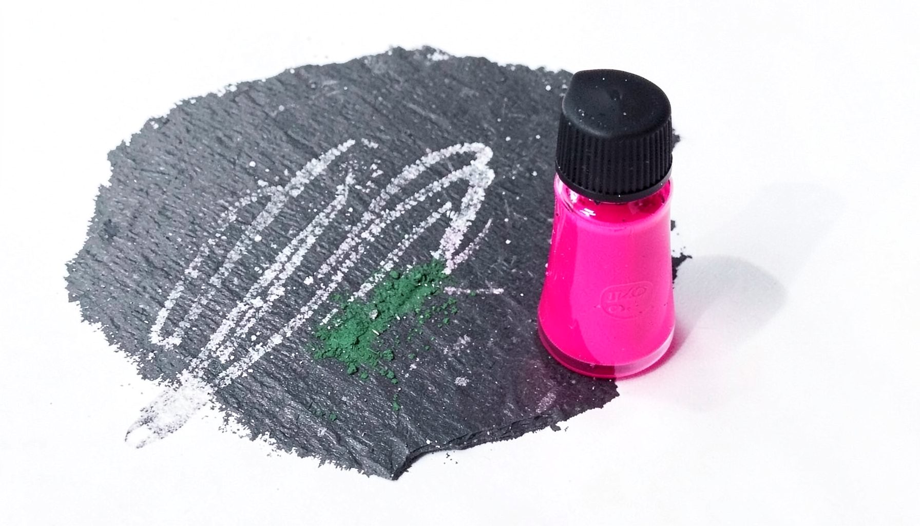 A bottle of vivid hot-pink stamping polish beside a silicone stamper head, both on a clean white backdrop.